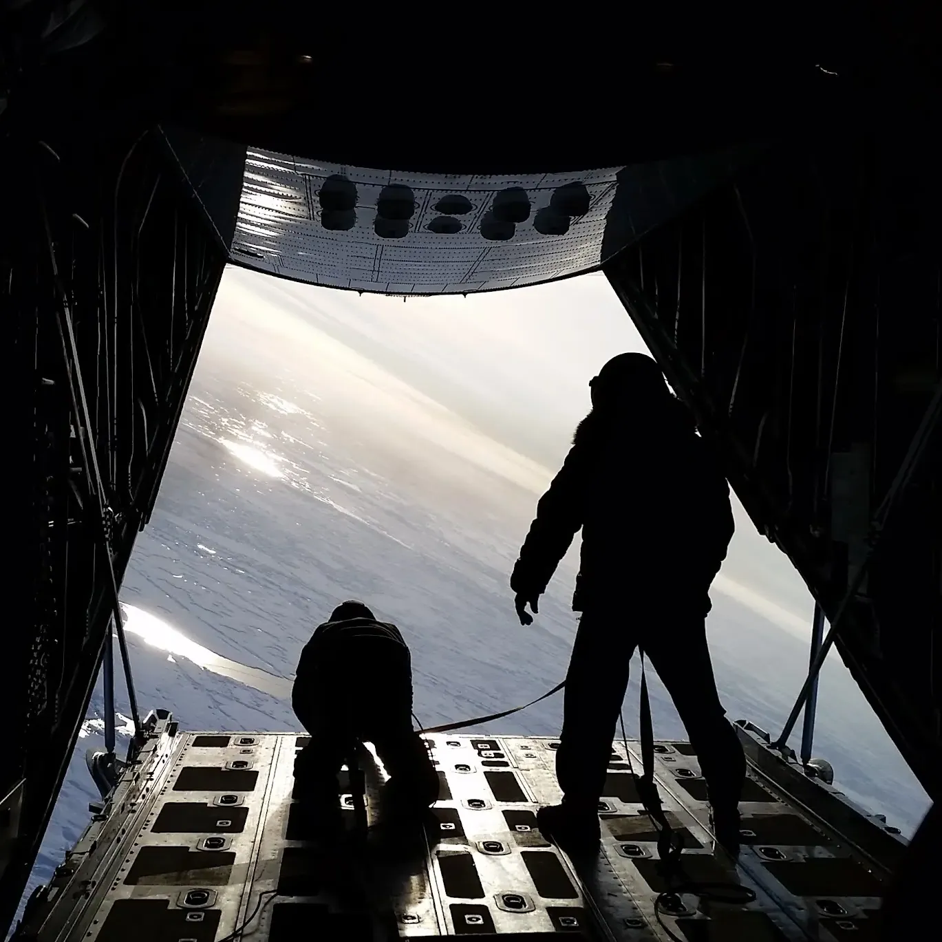 Steenson and another person standing at the exit door of an airplane that looks over ice